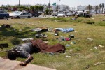Bodies lay outside the south gate of Gaddafi's Bab al-Aziziya compound as rebels make the final push to flush Gaddafi's forces from the compound in Tripoli